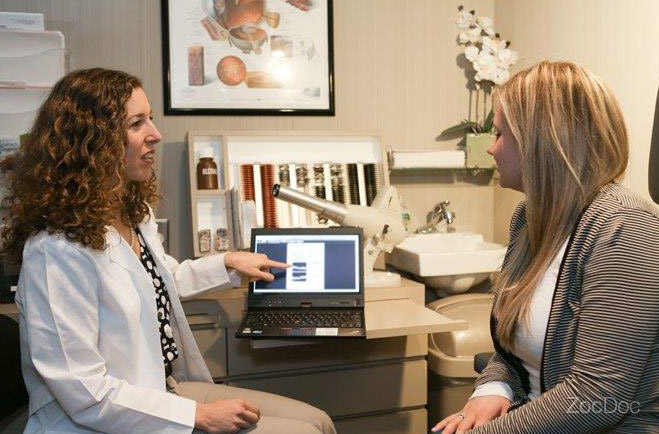 ophthalmologist discussing eye care with a patient during an eye exam