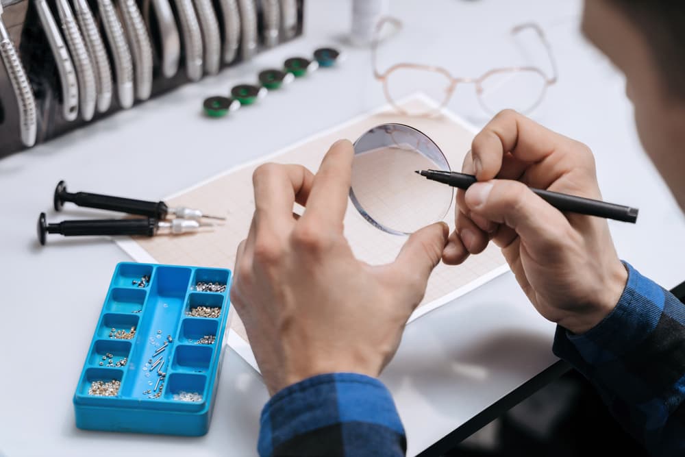 optometrist working on a lens